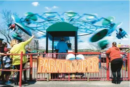  ?? COURANT FILE PHOTO ?? A ride operator runs the Paratroope­r ride as Quassy Amusement Park opened for the 2021 season.