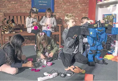  ?? Picture: Getty. ?? Children play with a selection of toys, including a Fisher-Price Batbox Extreme, during a media event announcing the top 12 toys for Christmas at St Mary’s Church in Marylebone.