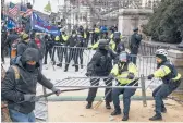 ?? KENNY HOLSTON/THE NEW YORK TIMES ?? Supporters of ex-President Trump clash with police at the U.S. Capitol. Two Capitol Police officers have filed a lawsuit against Trump.