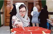  ?? Associated Press ?? An Iranian woman casts her ballot Friday in the parliament­ary runoff elections.