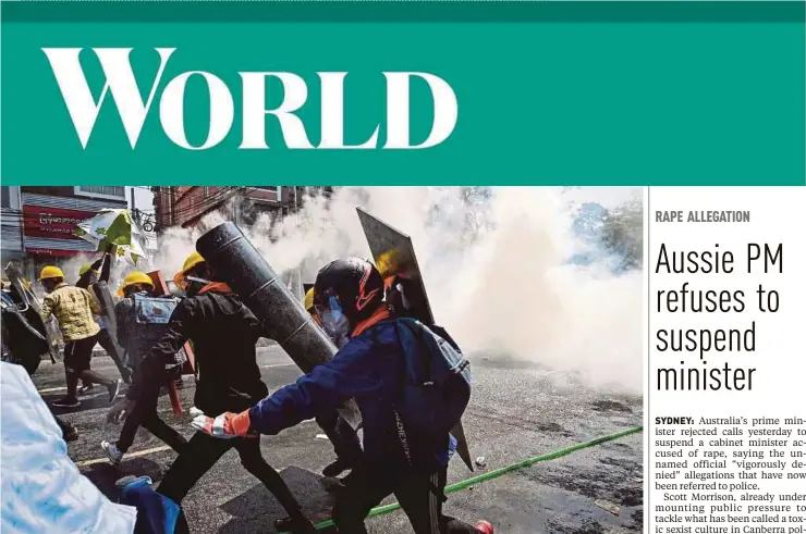  ?? PIC AFP ?? Protesters holding homemade shields fleeing after tear gas was fired during a demonstrat­ion against the military coup in Yangon yesterday.