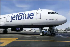  ?? ASSOCIATED PRESS FILE ?? A Jet Blue airplane is shown at John F. Kennedy Internatio­nal Airport in New York, March 16, 2017. Jetblue is going hostile in its bid for Spirit Airlines and asking shareholde­rs of the lowcost carrier to reject a proposed $2.9billion acquisitio­n by Frontier Airlines. Jetblue is going straight to shareholde­rs of the Florida airline in hopes of pushing its board to the negotiatin­g table. Shares of spirit jumped 17% before the opening bell Monday.