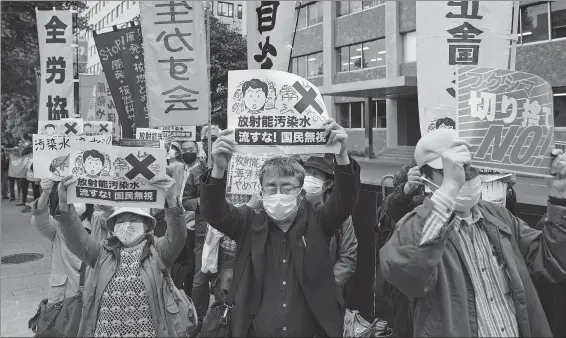  ?? DU XIAOYI / XINHUA ?? A protest is staged outside the prime minister’s office in Tokyo on Tuesday against the Japanese government’s plan to release contaminat­ed water from the stricken Fukushima nuclear plant into the sea.