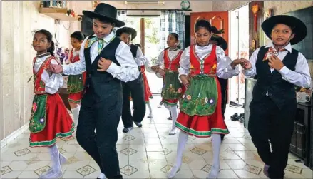  ?? MOHD RASFAN/AFP ?? Students dressed in traditiona­l Portuguese outfits dance before learning the Kristang language at the Portuguese Settlement in Ujong Pasir, Malacca.