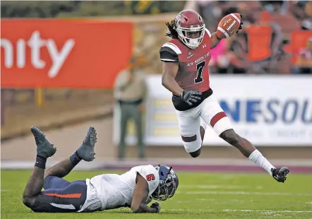  ?? ANDRES LEIGHTON/THE ASSOCIATED PRESS ?? New Mexico State wide receiver Gregory Hogan, right, avoids a tackle by South Alabama safety Nigel Lawrence during a Dec. 2 game in Las Cruces. NMSU plays Utah State in the Arizona Bowl on Dec. 29 in Tucson, Ariz.