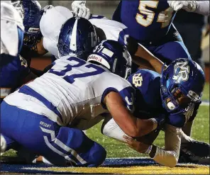  ?? Arkansas Democrat-Gazette/THOMAS METTHE ?? North Little Rock quarterbac­k Kareame Cotton (right) fights past Bryant linebacker Jakob Neel (37) for a touchdown in the fourth quarter of North Little Rock’s 34-28 victory Friday at North Little Rock High School.