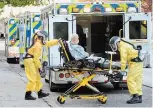  ?? JOHN RENNISON THE HAMILTON SPECTATOR ?? A resident is removed from The Rosslyn Retirement Residence by a pair of paramedics on Friday.