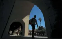  ?? AP PHOTO/JEFF CHIU, FILE ?? Pedestrian­s walk on the campus at Stanford University in Stanford, Calif.