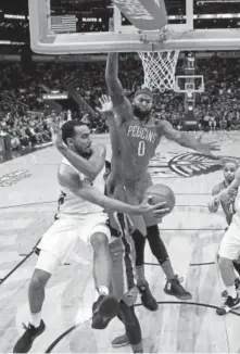  ?? The AP ?? Trey Lyles tries to pass the ball to a Denver teammate against DeMarcus Cousins in New Orleans on Wednesday night. Cousins’ 40 points helped the Pelicans beat the Nuggets 123-114.