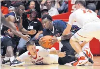  ?? JIM THOMPSON/JOURNAL ?? New Mexico’s Connor McDougall (55) hits the floor as he tries to knock the ball away from Fresno State’s Jaron Hopkins.