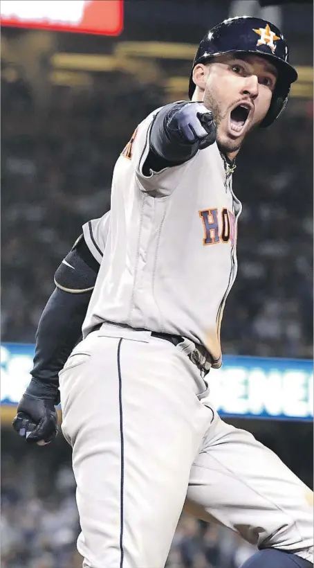  ?? Wally Skalij Los Angeles Times ?? AFTER STRIKING OUT four times in Game 1, George Springer celebrates the biggest hit in Game 2, a two-run homer in the 11th inning.