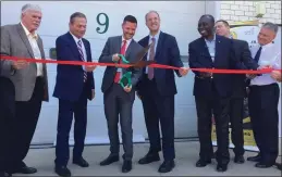  ??  ?? Flanked by state officials, Davies Tech Director Adam Flynn-Tabloff cuts the ribbon on the updated Center for Advanced Manufactur­ing.