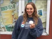  ?? THE CANADIAN PRESS ?? Emily Epp, 17, holds a shell she found on her swim around Bowen Island, B.C., on Saturday.