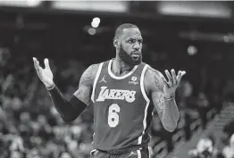  ?? Darron Cummings / Associated Press ?? Lakers star LeBron James made an obscene gesture after making a shot late in Los Angeles’ 124-116 overtime victory in Indiana on Wednesday night.