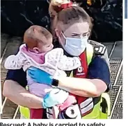  ??  ?? Rescued: A baby is carried to safety