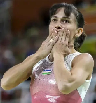  ?? Associated Press photos ?? Gymnast Oksana Chusovitin­a, from Uzbekistan, qualified for her eighth Olympics, breaking her own record in the sport.