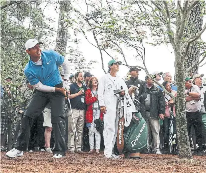  ?? DAVID J. PHILLIP/THE ASSOCIATED PRESS ?? Rory McIlroy found trouble on the second hole, but played his way into contention heading into the final round of the Masters.