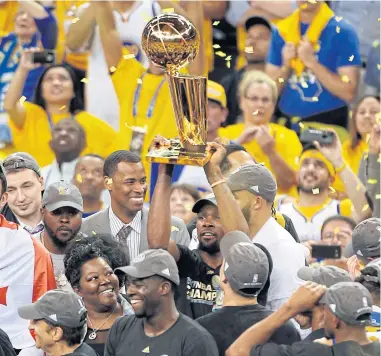 ?? USA TODAY SPORTS ?? Golden State’s Kevin Durant hoists the Larry O’Brien Trophy after the Warriors defeated the Cavaliers in the NBA Finals.