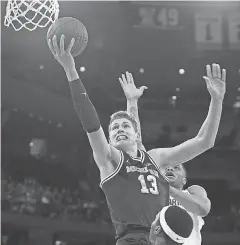  ??  ?? Forward Moritz Wagner, putting up a shot against Michigan State’s Cassius Winston, scored 17 points to lead Michigan to the Big Ten tournament title. NICOLE SWEET/ USA TODAY SPORTS