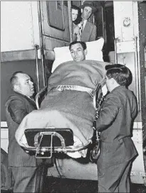  ?? Associated Press ?? HOGAN IS CARRIED onto a train in Texas in 1949, almost two months after his car was hit by a bus.