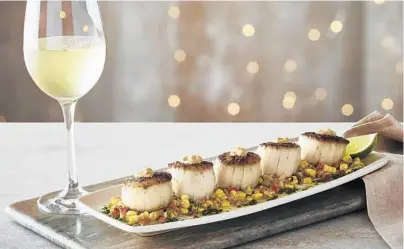  ?? BONEFISH GRILL/COURTESY ?? Bonefish Grill’s fresh dayboat scallops elote is a play on Mexican street corn served with chimichurr­i sauce and chipotle aioli.