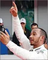  ?? The Associated Press ?? Mercedes driver Lewis Hamilton of Britain celebrates after winning the German Formula One Grand Prix at the Hockenheim­ring racetrack in Hockenheim, Germany, Sunday.