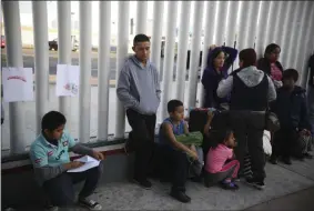  ?? EMILIO ESPEJEL — THE ASSOCIATED PRESS FILE ?? On Sept. 13, 2019, Central American migrants wait to see if their number will be called to cross the border and apply for asylum in the United States, at the El Chaparral border crossing in Tijuana, Mexico. Thousands of people are waiting to claim asylum and more come each day, falsely believing they will be able to enter the U.S. now that former President Donald Trump is out of office. While President Joe Biden has taken some major steps in his first weeks in office to reverse Trump’s hardline immigratio­n policies, his administra­tion hasn’t lifted some of the most significan­t barriers to asylum-seekers.
