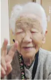  ??  ?? Kane Tanaka flashes a peace sign during her 115th birthday celebratio­n in Fukuoka, Japan.