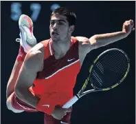  ?? JASON O’BRIEN EPA ?? CARLOS Alcaraz of Spain serves during his second round match against Dusan Lajovic of Serbia at the Australian Open in Melbourne. |