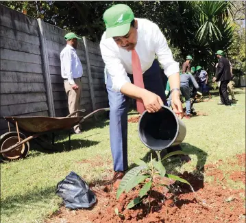  ??  ?? TREE OF FRIENDSHIP . . . Ethiopian Ambassador to Zimbabwe Dr Addisu Gebreigzab­hier plants a tree at the embassy in Harare on Monday. — (Picture by Tawanda Mudimu)