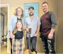  ?? ?? On Feb. 3, Aaron Goodvin, centre, performed a private concert for Janelle Gallant, left, Logan MacKinnon, right, and their daughter Dayla Gallant.