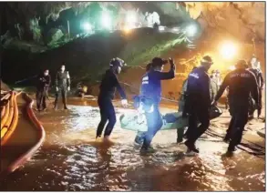  ?? AP ?? An undated photo released Wednesday by Thai navy SEALS shows rescuers holding an evacuated boy inside the Tham Luang Nang Non cave.