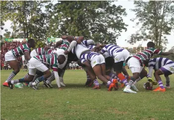  ?? ?? POWER PLAY . . . Prince Edward forwards (left) and their Churchill opponents engage in a scrummage during their match at Prince Edward yesterday. Picture — Nicholas Bakili