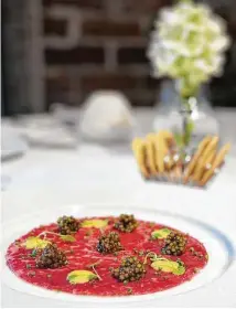  ?? Emeril's ?? Chef Emeril Lagasse offers beef carpaccio with caviar at Emeril’s, his newly reopened signature restaurant.