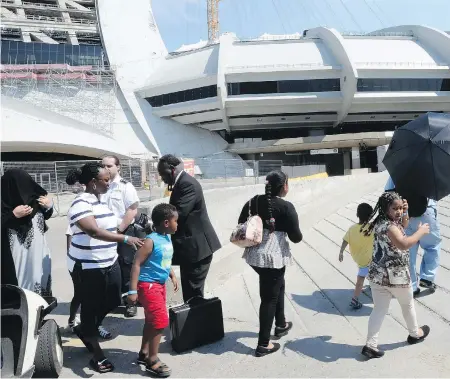  ?? RYAN REMIORZ / THE CANADIAN PRESS ?? Officials have opened up Montreal’s Olympic Stadium to shelter the wave of Haitian refugee claimants that have crossed into Canada from the U.S.