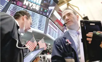  ?? — Reuters ?? Traders work on the floor of the New York Stock Exchange in New York.