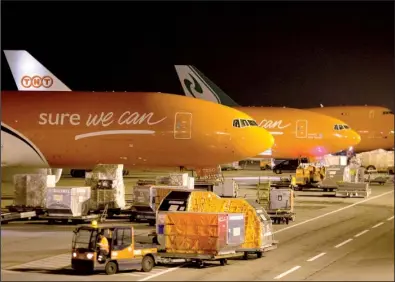  ?? Bloomberg News/JASPER JUINEN ?? Cargo jets stand on the apron at TNT Express NV’s European mail hub at Leige Airport in Grace-Hollogne, Belgium, last month. European Union regulators fear higher delivery prices from a tie-up of FedEx and TNT Express.
