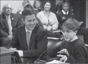  ?? Arkansas Democrat-Gazette/BENJAMIN KRAIN ?? Mason Cyprus Oury, a Fayettevil­le High School senior, accompanie­d by Rep. Greg Leding, D-Fayettevil­le, gives a presentati­on Wednesday to a House panel on why the Arkansauru­s fridayi should become the state dinosaur. Leding submitted a bill calling for...