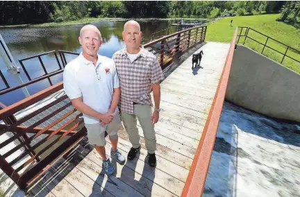  ?? MIKE DE SISTI / MILWAUKEE JOURNAL SENTINEL ?? John Taylor (left) and Dave Porter have asked a judge to settle their ownership of Upper Spring Lake, which the state also claimed after Taylor and Porter rebuilt the dam that makes the lake. For more photos and a video, see jsonline.com/news.