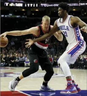  ?? MATT SLOCUM — THE ASSOCIATED PRESS ?? Joel Embiid defends against Portland Trail Blazers forward Mason Plumlee on Friday.