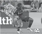  ?? ADAM CAIRNS/COLUMBUS DISPATCH ?? Crew midfielder Yaw Yeboah, right, fights for the ball with New York Red Bulls midfielder Peter Stroud. There were 27 fouls called in Saturday's match.