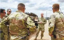  ?? SENIOR AIRMAN KRISTIN SAVAGE VIA AP ?? Army Brig. Gen. Damian T. Donahoe speaks with U.S. ser vice members in Somalia in September.