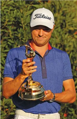  ?? Picture: AFP ?? WHAT A BEAUTY. American Justin Thomas admires his trophy after winning The Players Championsh­ip at TPC Sawgrass in Ponte Vedra Beach on Sunday.