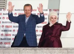  ??  ?? ANKARA: Turkish president Recep Tayyip Erdogan and his wife Ermine wave to supporters from the balcony of the AK party headquarte­rs. —AFP