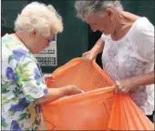  ??  ?? Bev Fowles tells Forest Hills resident Margaret Bailey what she can and cannot recycle at the Kloof Recycling centre.