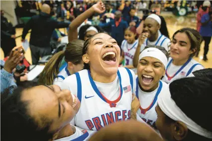  ?? BILLY SCHUERMAN/STAFF PHOTOS ?? Princess Anne’s Celeste Bailey, center, is swarmed by teammates as they celebrate their Class 5 state semifinal victory over Deep Creek on Friday night at Echols Hall in Norfolk.