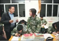  ?? PHOTOS PROVIDED TO CHINA DAILY ?? From left: Zhang Juncheng answers a student’s questions during a regular check on the pupils’ studies at the vocational secondary school he establishe­d in Shanxi province. Zhang studies on the campus of Peking University in 1997.