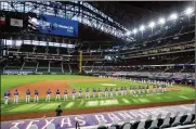  ??  ?? The Rangers and Rockies line the foul lines of Globe Life Field in Arlingtn, Texas, before their opening day game on July 24. The Texas Rangers could have a full house for their home opener next month.