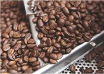  ??  ?? COFFEE BEANS are seen in a roaster at a stand at the Coffee Fair in Lima, Peru, Aug. 25.