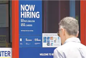  ?? ALAN DIAZ THE ASSOCIATED PRESS ?? A ‘Now Hiring’ sign welcomes a customer entering a Best Buy store in May in Hialeah, Fla. U.S. employers added a robust 222,000 jobs in June, the most in four months, a reassuring sign that businesses may be confident enough to keep hiring despite a...